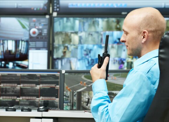 Man in Front of Security Monitors for Alarm Monitoring Services in Pasadena, CA