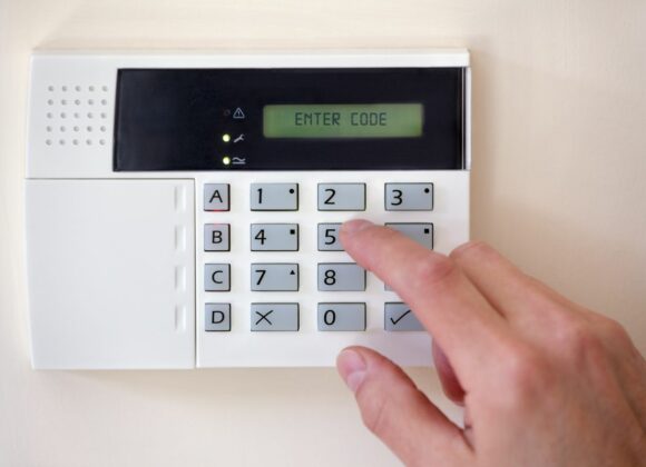 hand inputting the code to a burglar alarm in Glendale