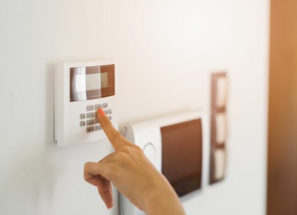 Hand Entering Code on Alarm Panel for Security Systems in Pasadena, CA